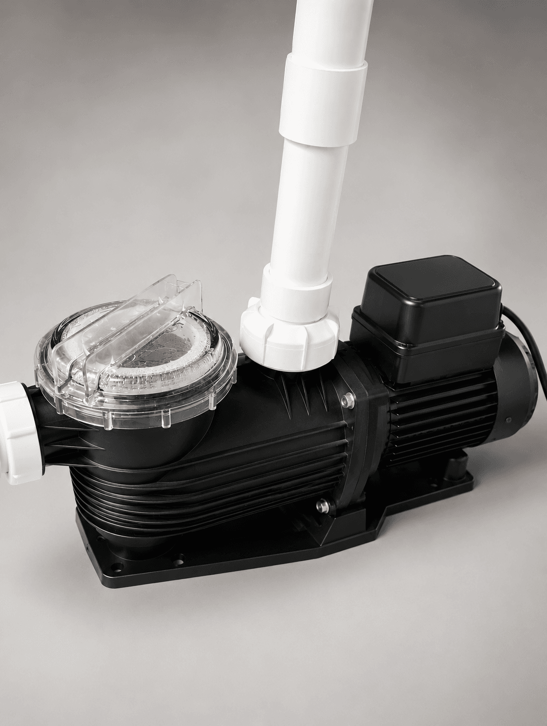 Black swimming pool pump with clear strainer lid and white PVC piping for pool filtration system installation in Melbourne